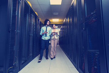 Image showing engineer showing working data center server room to female chief