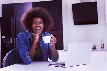 Image showing smiling black woman in modern kitchen