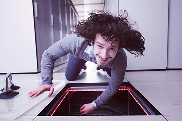 Image showing engineer connecting cables in server room