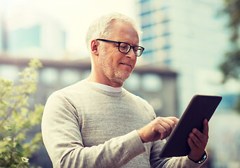 Image showing senior man with tablet pc on city street