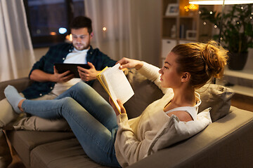 Image showing couple with tablet computer and book at home