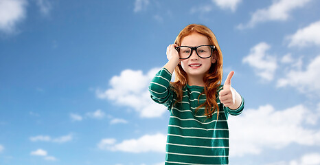 Image showing red haired student girl in glasses over blue sky