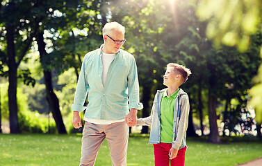 Image showing grandfather and grandson walking at summer park