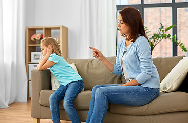 Image showing angry mother scolding her daughter at home