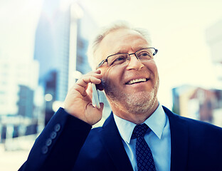 Image showing smiling old businessman calling on smartphone