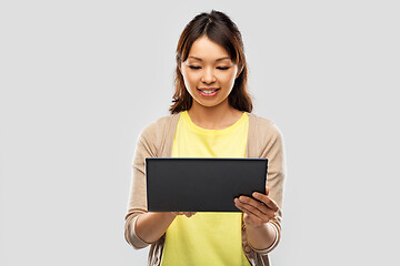 Image showing happy asian woman using tablet computer