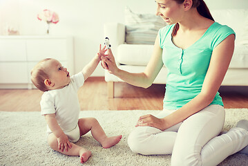 Image showing happy mother and baby playing at home