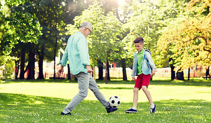 Image showing old man and boy playing football at summer park