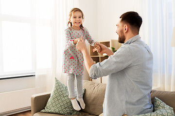 Image showing father and daughter jumping and having fun at home