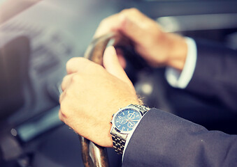 Image showing senior businessman hands driving car