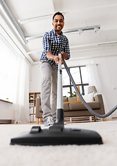 Image showing indian man with vacuum cleaner at home
