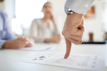 Image showing close up of businessman with charts at office