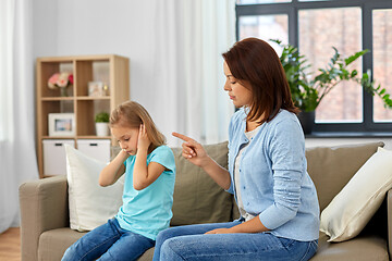 Image showing angry mother scolding her daughter at home