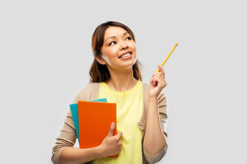 Image showing asian student woman with books and pencil