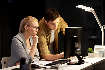 Image showing business team with computer at night office