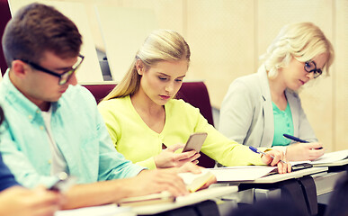 Image showing student girl with smartphones at lecture