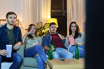 Image showing friends with beer and popcorn watching tv at home