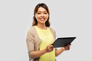 Image showing happy asian woman using tablet computer