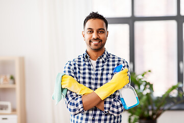 Image showing smiling indian man with detergent cleaning at home