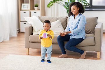 Image showing mother and baby playing with ball at home