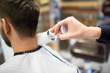 Image showing barber with brush cleaning male neck at barbershop