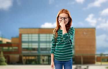 Image showing red haired student girl in glasses over school