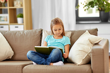 Image showing little girl reading book at home