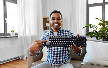 Image showing male blogger with keyboard videoblogging at home