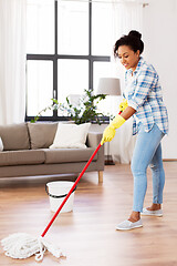 Image showing african woman or housewife cleaning floor at home