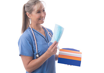 Image showing A nurse handing out medical masks