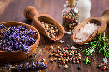 Image showing Salt, pepper with rosamary and lavender on wooden background