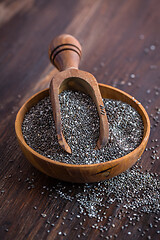 Image showing Chia seeds with spoon in the bowl on the wooden background