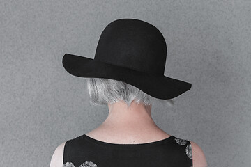 Image showing Gray-haired lady wearing black hat