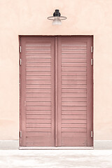 Image showing Pink building with a wooden door