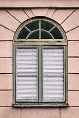 Image showing Pink building with rounded green window