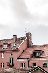 Image showing Tiled rooftops of pink European buildings