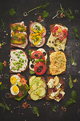 Image showing Top view of different decorated sandwiches as appetizer. Healthy food. Vegetable meal