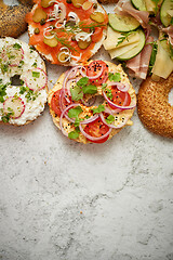 Image showing Homemade Bagel sandwiches with different toppings, salmon, cottage cheese, hummus, ham, radish