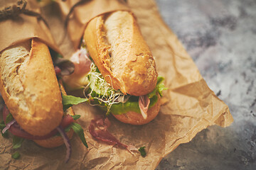 Image showing Tasty homemade sandwiches Baguettes with various healthy ingredients. Breakfast take away concept