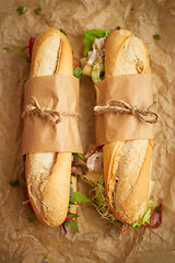 Image showing Tasty homemade sandwiches Baguettes with various healthy ingredients. Breakfast take away concept