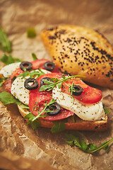 Image showing Delicious fresh Bruschetta with tomato, basil, black olives and mozarella cheese