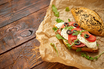 Image showing Delicious fresh Bruschetta with tomato, basil, black olives and mozarella cheese