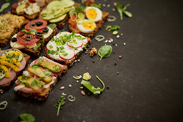 Image showing Top view of different decorated sandwiches as appetizer. Healthy food. Vegetable meal