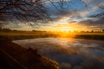 Image showing Ground fog creeps across the landscape on Autumn morning 