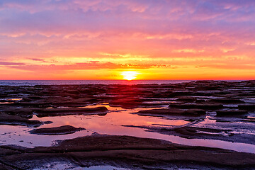 Image showing Pretty sunrise over the ocean and beach