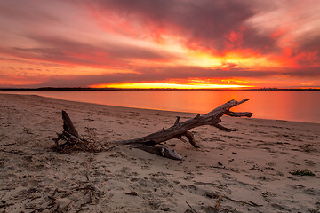 Image showing Vivid strong orange and red colours of the sunset across the bea