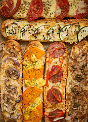 Image showing Assortment of various toppings baked sandwiches. With melted che