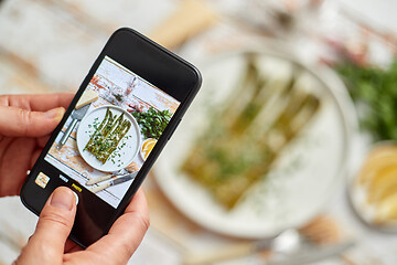 Image showing Woman taking picture of fresh prepared food with smartphone for 