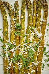 Image showing Close up. Hot fresh roasted asparagus with parmesan cheese and parsley. Healthy spring food concept