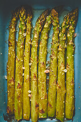 Image showing Close up with selective focus on roasted asparagus seasoned with